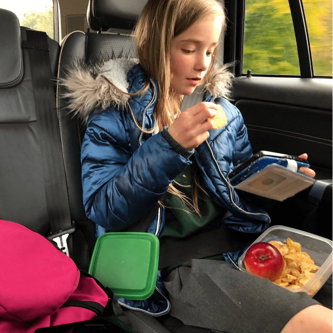 girl eating snacks in a car